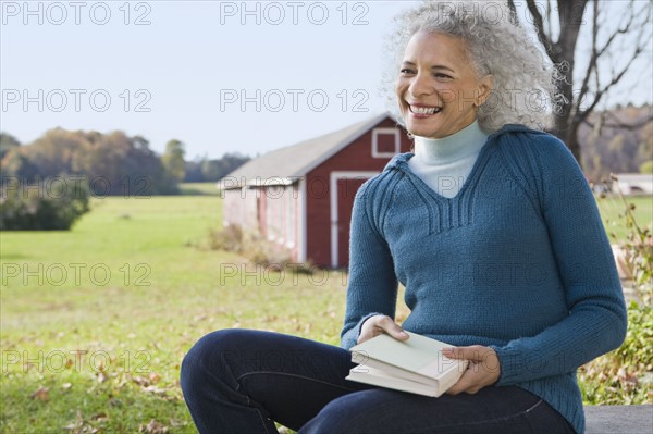 Woman holding a book. Photographer: Pauline St.Denis