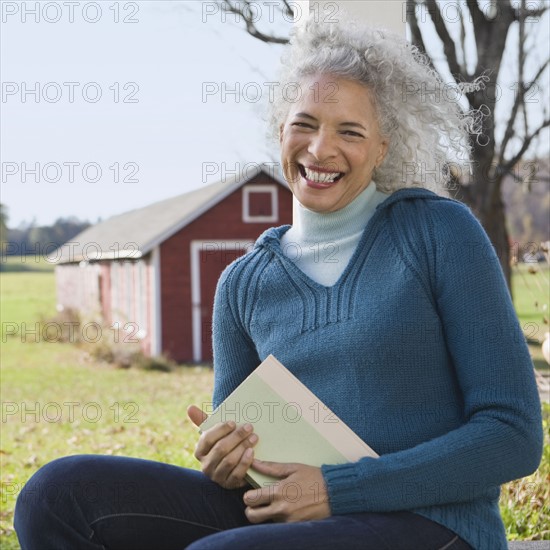 Woman holding a book. Photographer: Pauline St.Denis