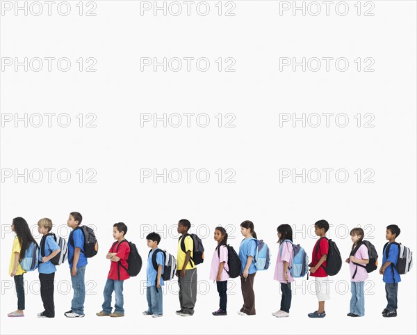Line of children wearing backpacks. Photographer: momentimages