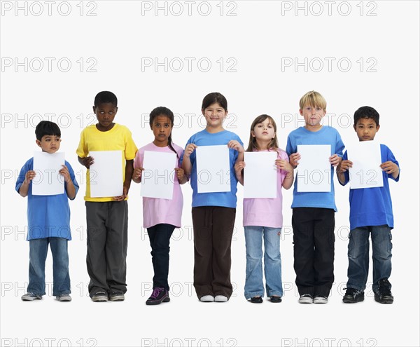 Children holding paper. Photographer: momentimages