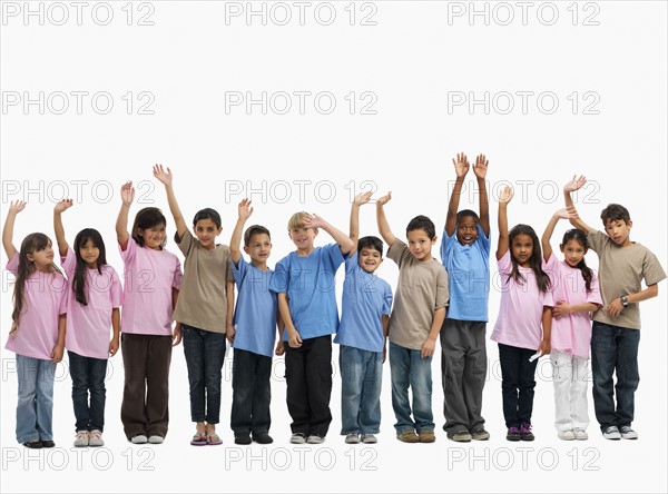 Children raising their hands. Photographer: momentimages
