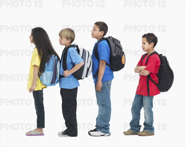 Line of children wearing backpacks. Photographer: momentimages