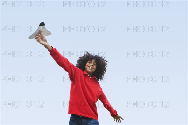 Woman flying toy plane. Photographer: Pauline St.Denis