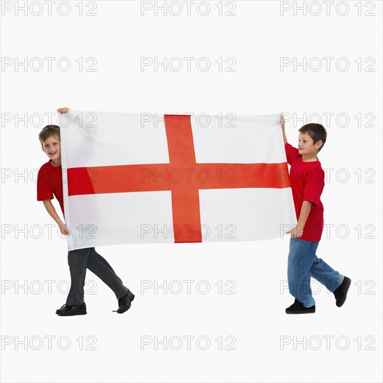 Two boys carrying flag. Photographer: momentimages