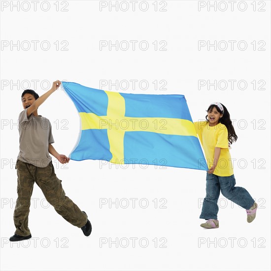 Children carrying flag. Photographer: momentimages