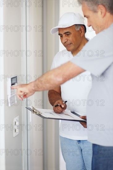 Man testing alarm system. Photographer: momentimages