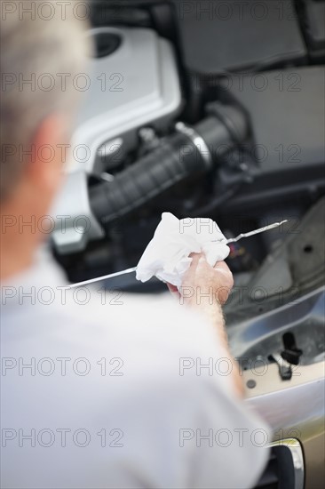 Checking the oil. Photographer: momentimages