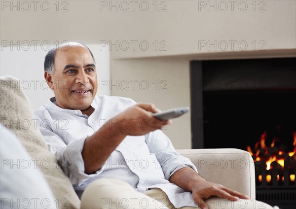 Man watching television. Photographer: momentimages