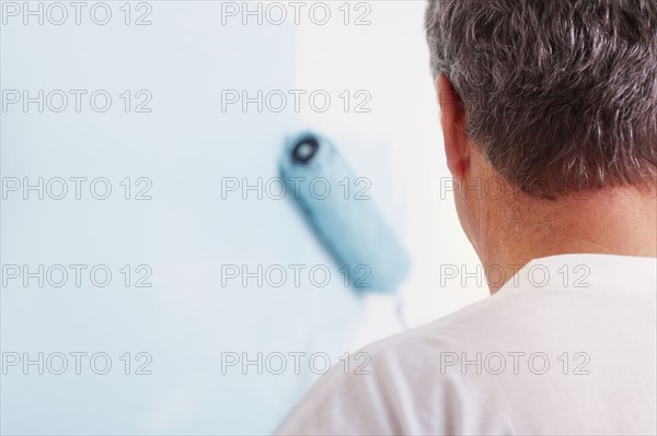 Man painting wall. Photographer: momentimages