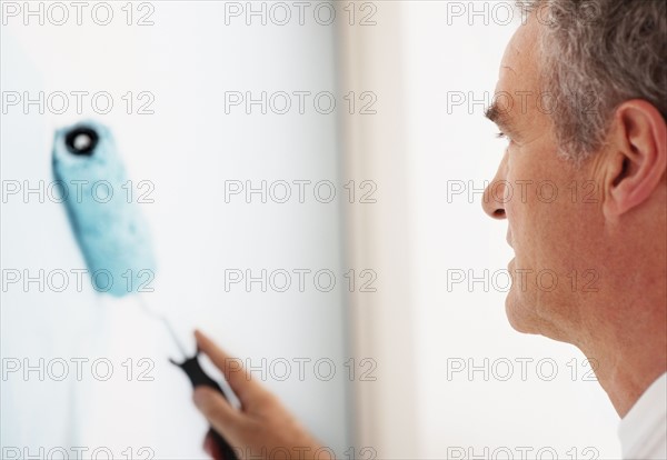 Man painting wall. Photographer: momentimages