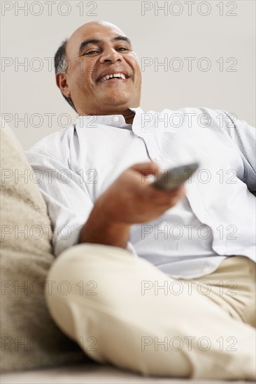 Man watching television. Photographer: momentimages