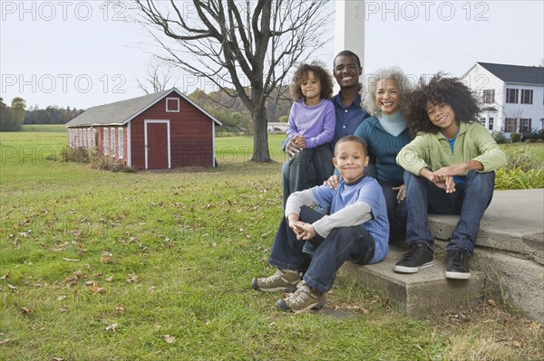 Family sitting on porch. Photographer: Pauline St.Denis