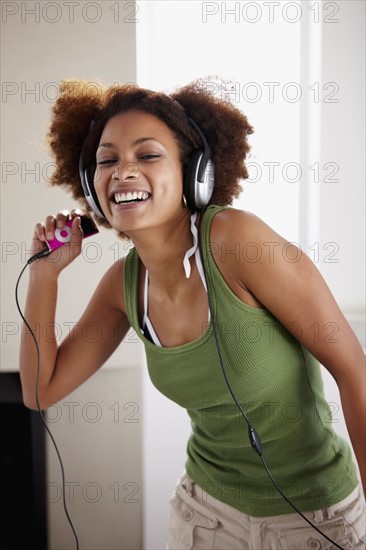 Woman listening to music. Photographer: momentimages