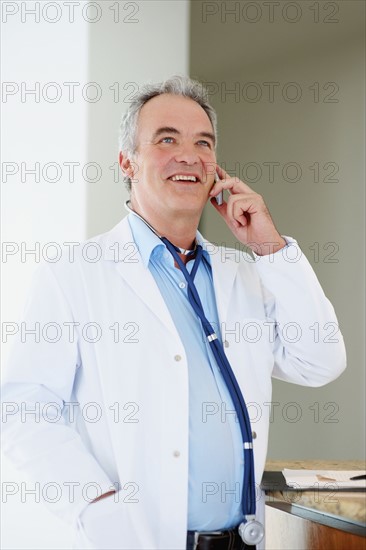 Doctor talking on phone. Photographer: momentimages