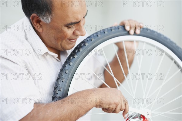 Man repairing bicycle. Photographer: momentimages