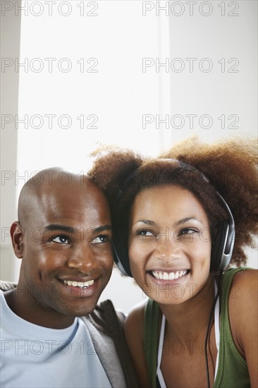 Woman listening to music on headphones. Photographer: momentimages