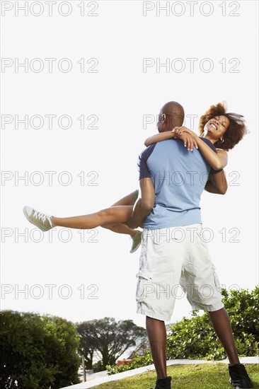 Man carrying woman. Photographer: momentimages