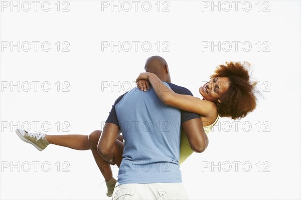 Man carrying woman. Photographer: momentimages
