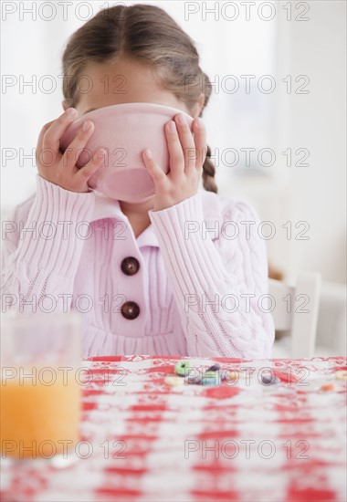 Young girl eating. Photographer: Jamie Grill