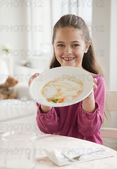 Young girl holding plate. Photographer: Jamie Grill