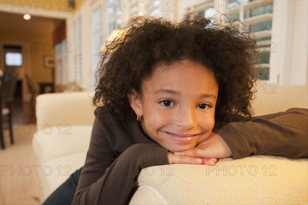 Young girl on couch. Photographer: mark edward atkinson