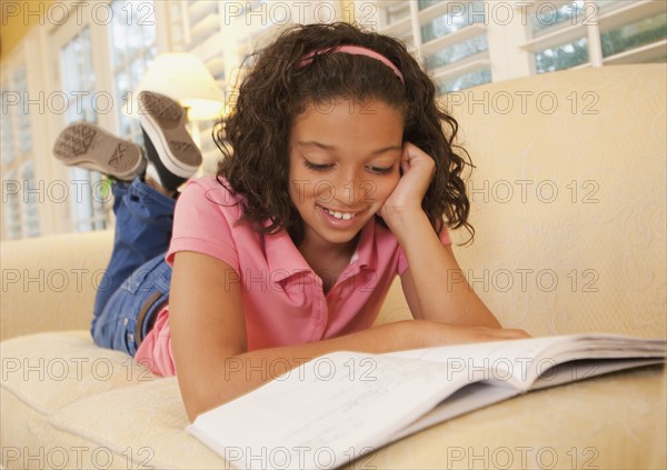 Young girl on couch. Photographer: mark edward atkinson