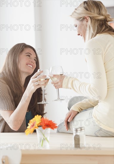 Friends drinking wine. Photographer: Jamie Grill