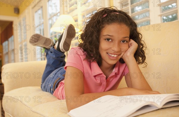 Young girl on couch. Photographer: mark edward atkinson