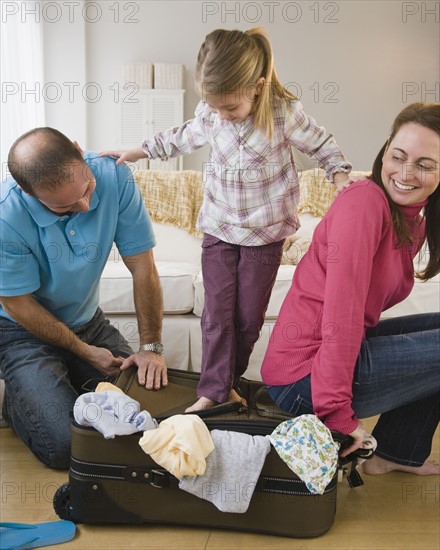 Packing for family vacation. Photographer: Jamie Grill