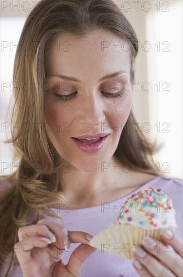 Woman eating cupcake.