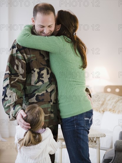 Family embracing. Photographer: Jamie Grill