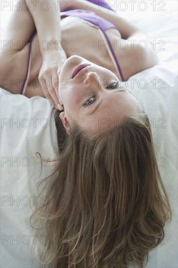 Woman lying on bed.