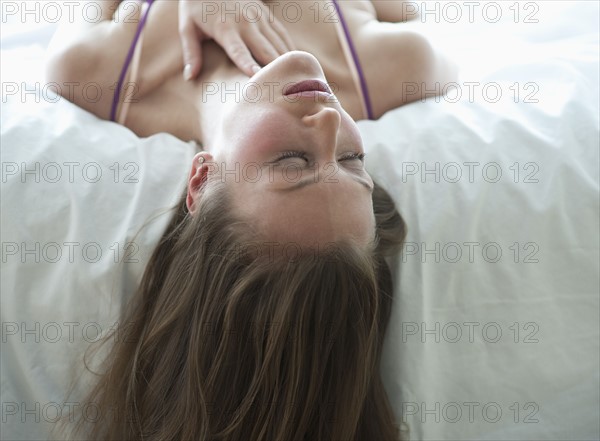 Woman lying on bed.