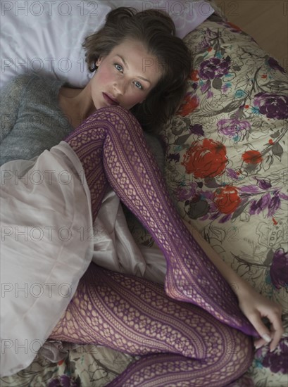 Woman lying down on bed.