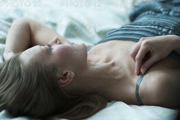 Woman lying down on bed.