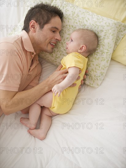 Father resting with baby.