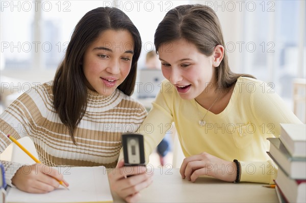 Students looking at cell phone.