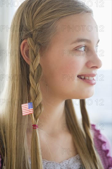 Young girl with American flag in hair.