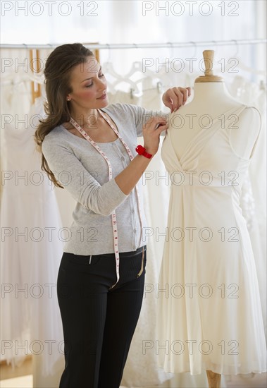 Seamstress in bridal shop.