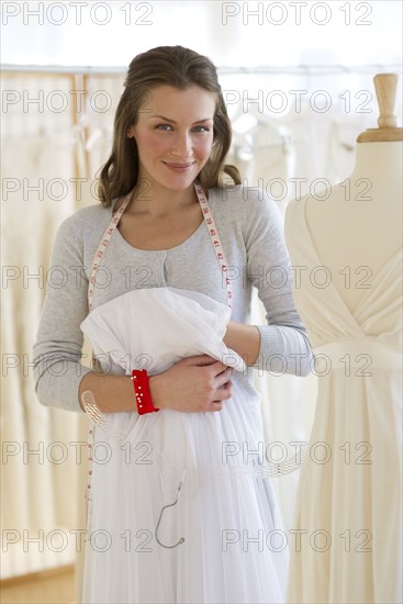 Seamstress in bridal shop.