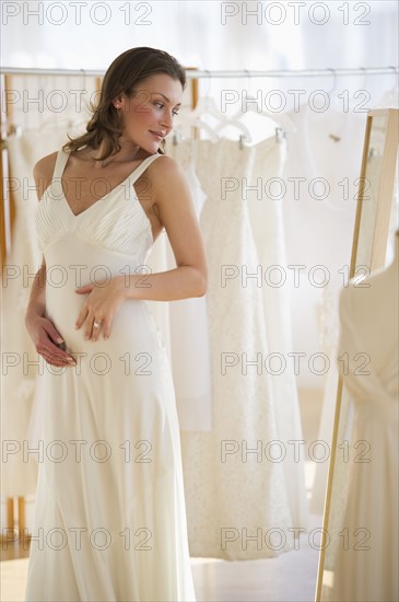 Woman trying on wedding dress.