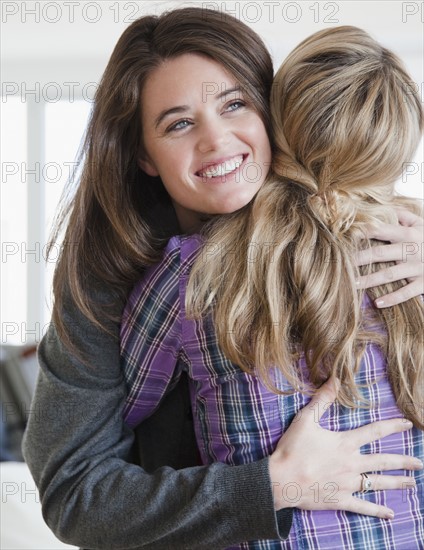 Friends hugging. Photographer: Jamie Grill