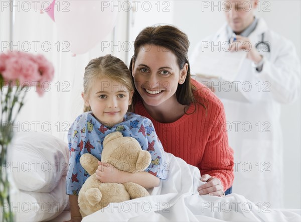 Mother and daughter in hospital. Photographer: Jamie Grill