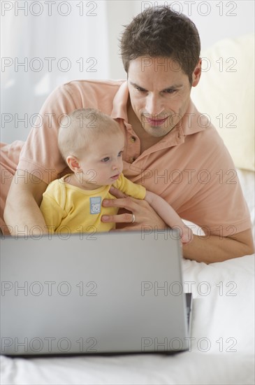 Father working on laptop.