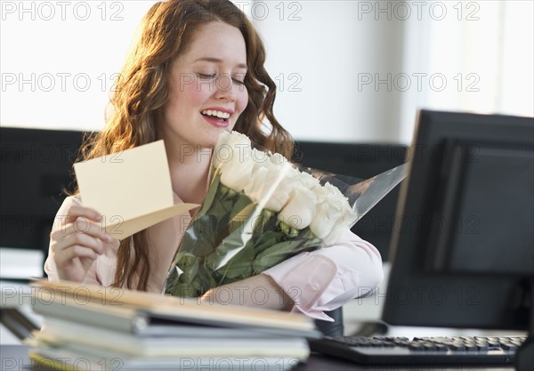 Woman holding bouquet of flowers.