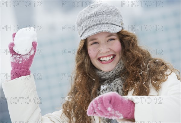 Woman throwing a snowball.