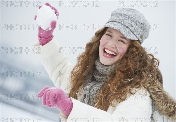 Woman throwing a snowball.