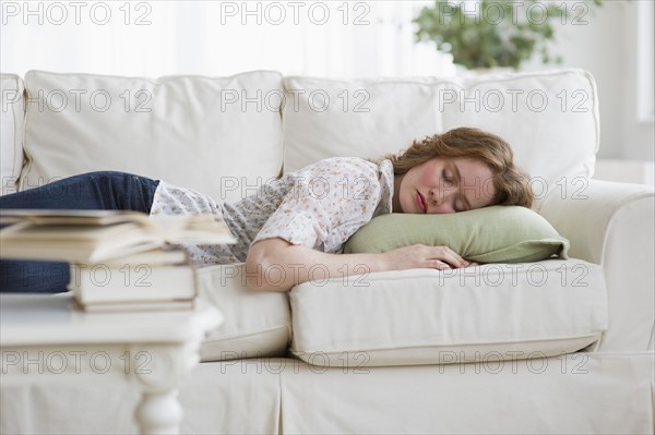 Woman napping on couch.