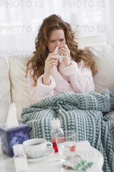 Sick woman on couch.