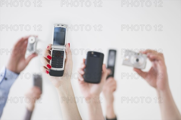 Hands holding wireless devices.